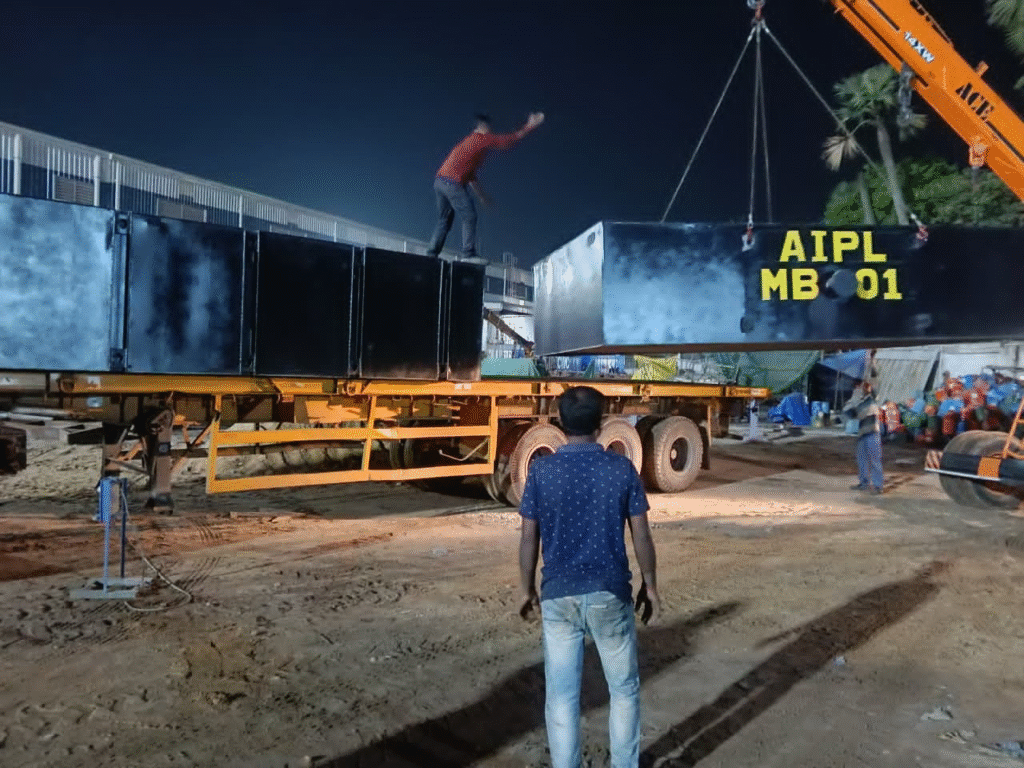 Crane unloading modular sectional barge module from truck trailer for on-site assembly and deployment